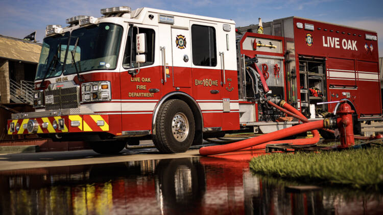 A side view of a Live Oak Fire Department fire truck connected to a fire hydrant—Mercedes Textiles Know Your Hose Resource