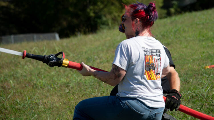 Mercedes Textiles' marketing director flowing a fire hose prototype